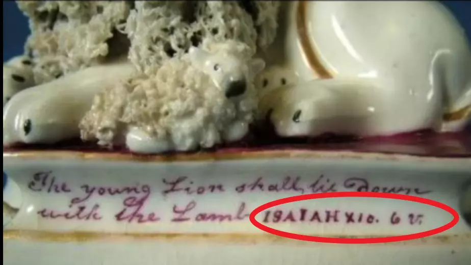 LION AND LAMB TEXT BELOW STATUE SHOWING ISAIAH 11:6 IN ROMAN NUMERALS
